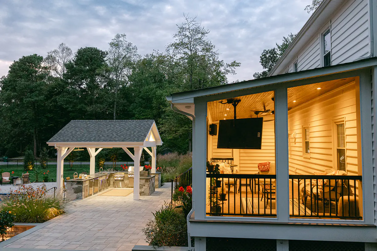 cozy deck with warm lighting and pavilion in backyard