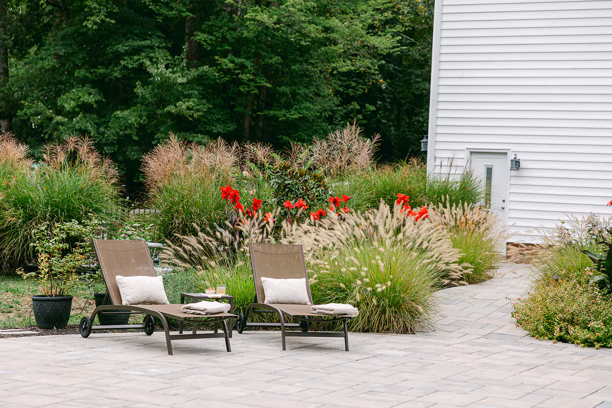 pool chairs by greenery and landscaping