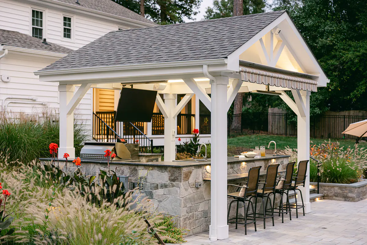 custom built pavilion with outdoor kitchen and bar seating
