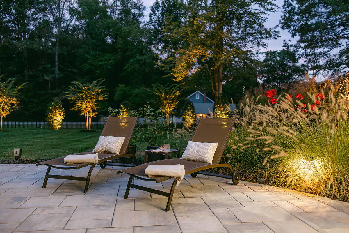 pool chairs and landscaping at night