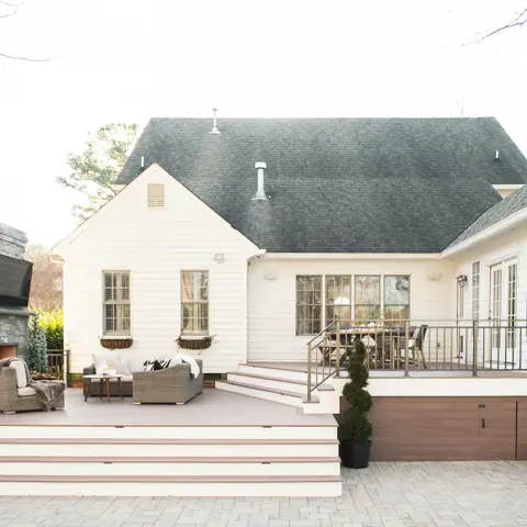 backyard deck and patio connected to cream house