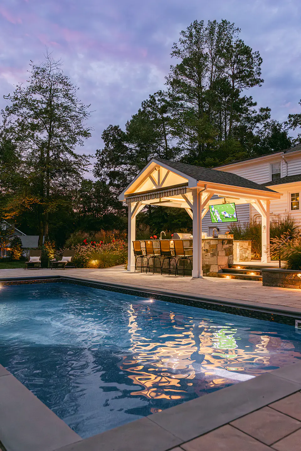 pool at night in backyard at night with pavilion and lights in Virginia