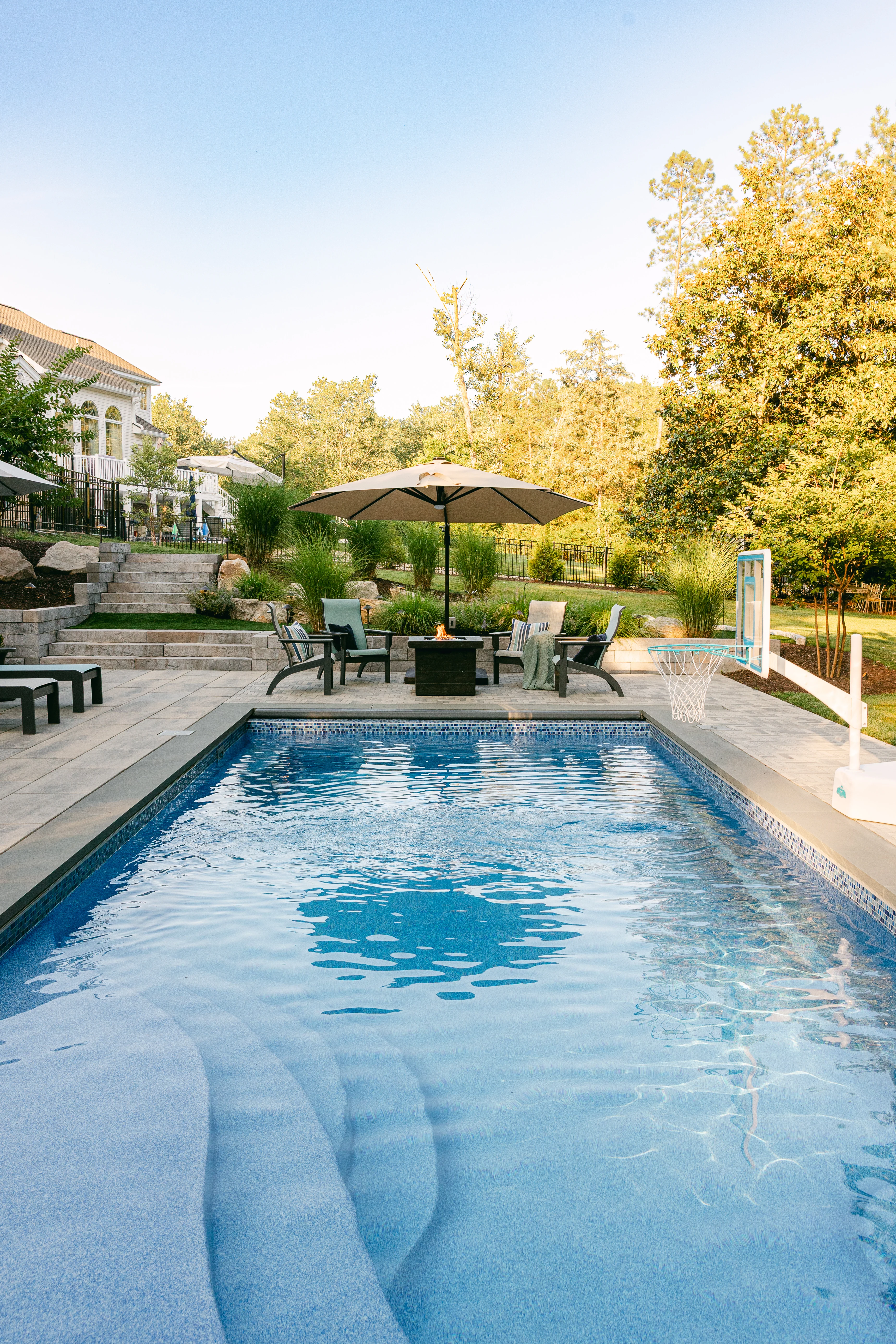 Gunite pool with hot tub and stone patio and pool decking