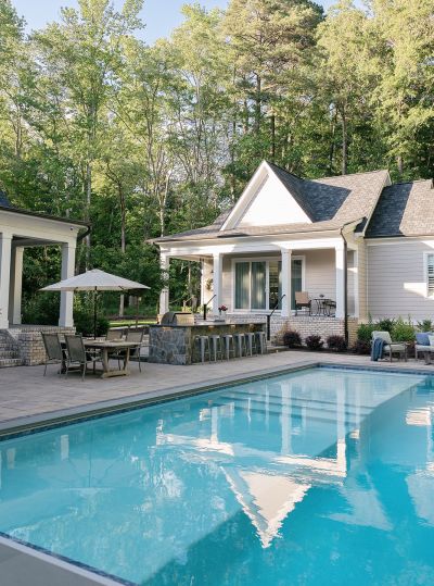 Gunite pool with hot tub and stone patio and pool decking