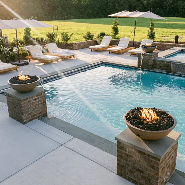 Built-in fire bowl feature set into modern pool design