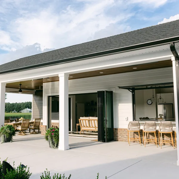 Brick pool house with automatic bar window and integrated outdoor living space