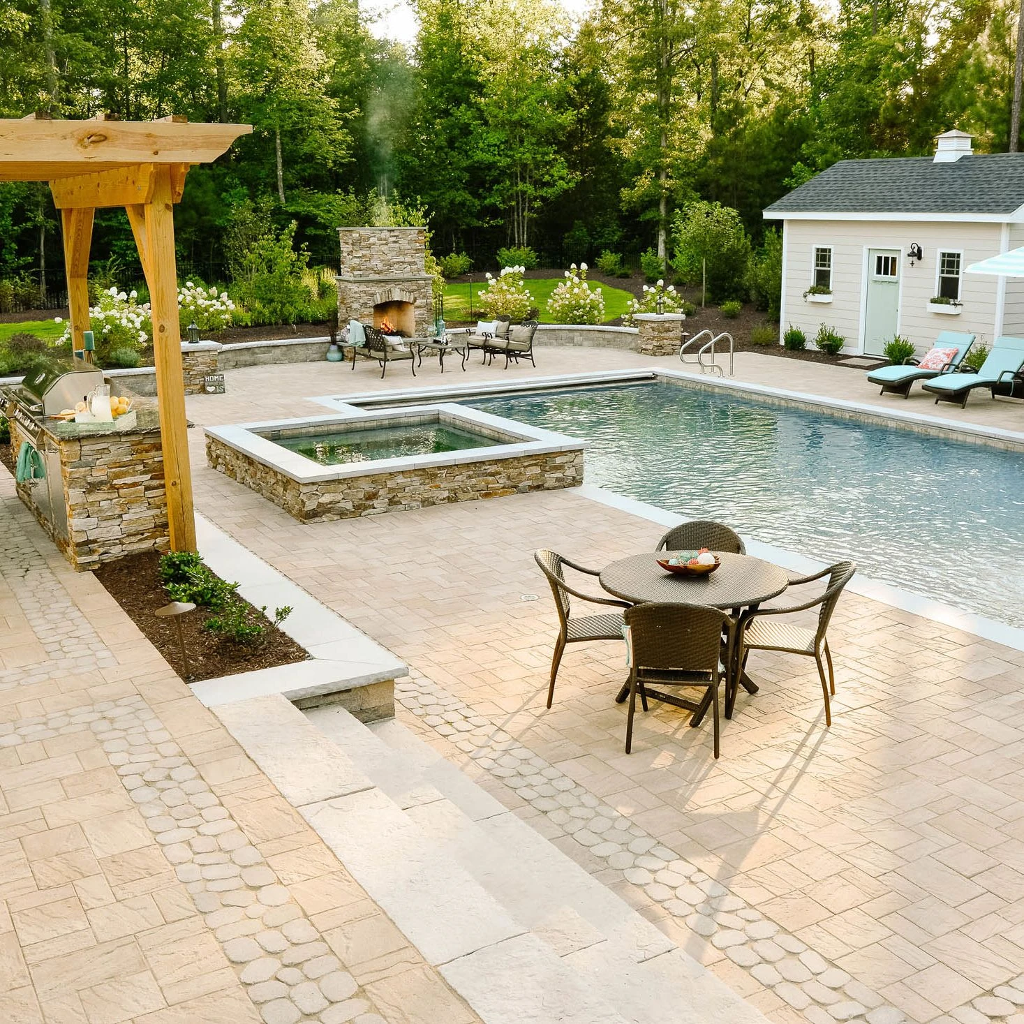 Classic backyard landscaping with a fiberglass pool and hut tub