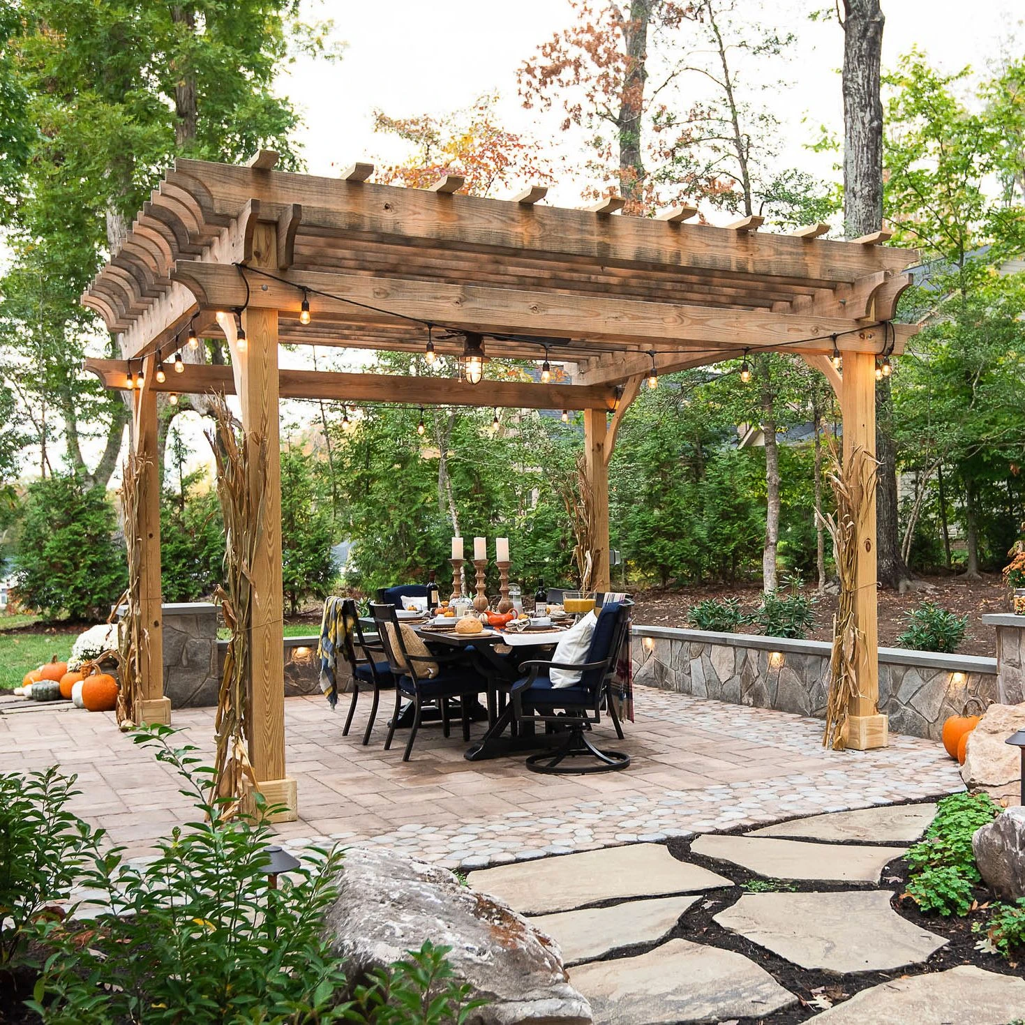 Rustic Pergola covering backyard dining area with knee walls surrounding it