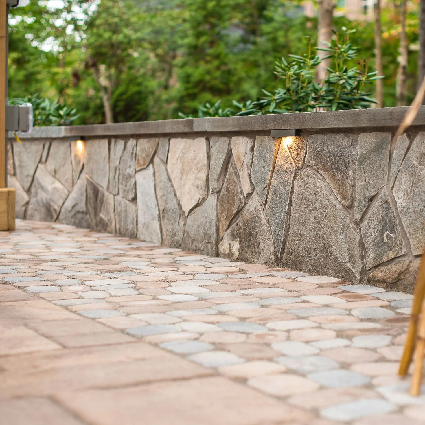 sitting stone wall and paver patio in hardscape backyard project