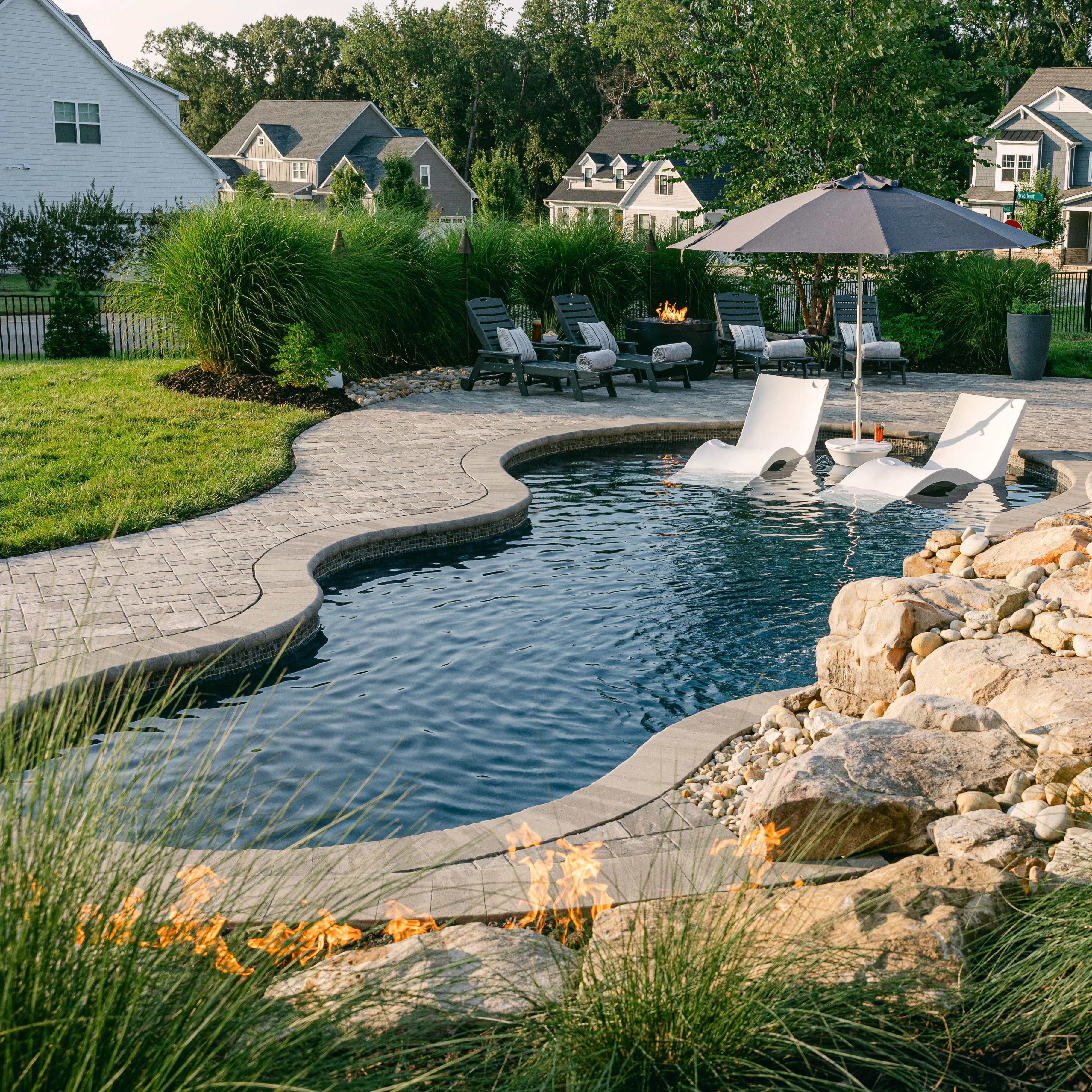 	Custom-shaped fiberglass swimming pool in luxury backyard