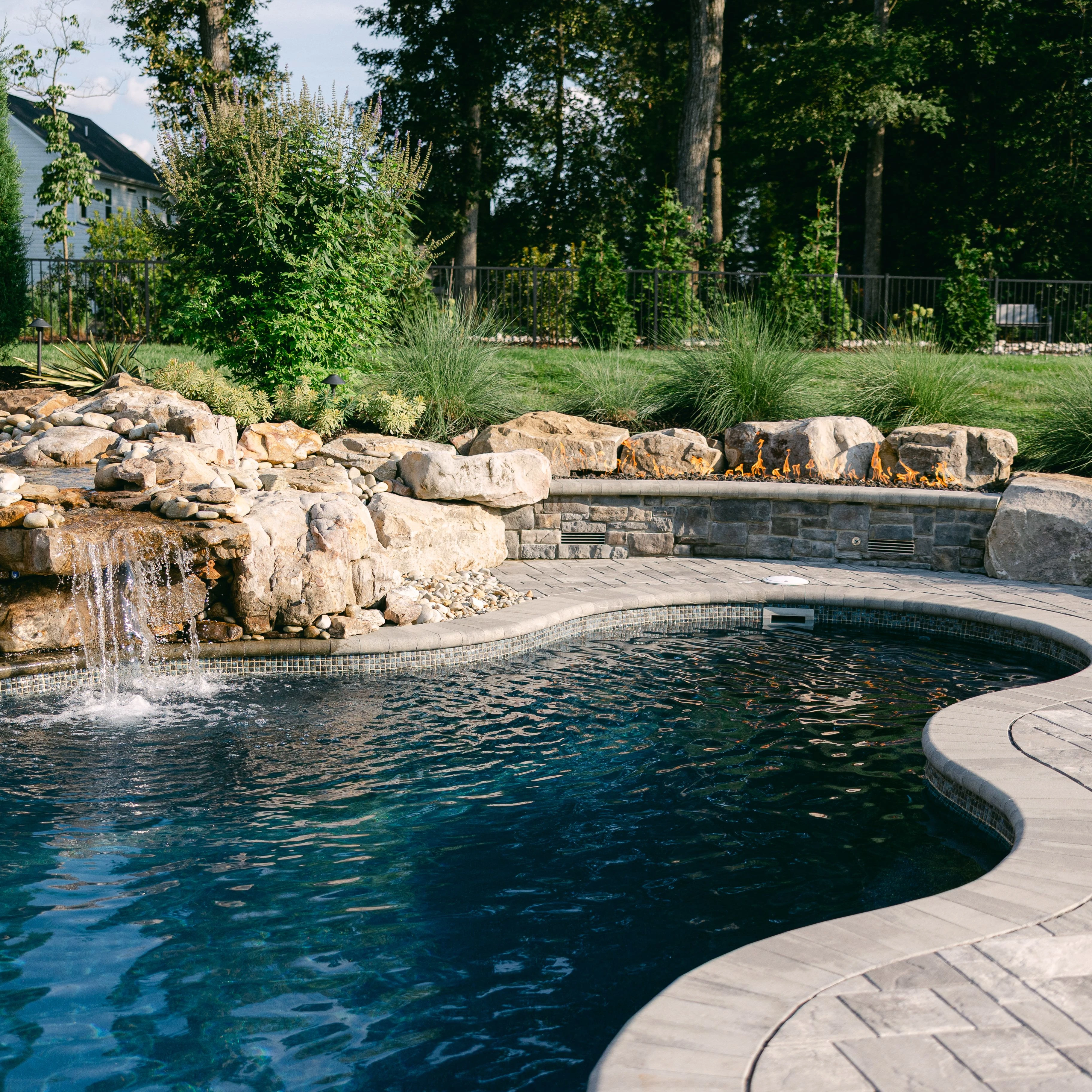 Elegant backyard freeform fiberglass pool design