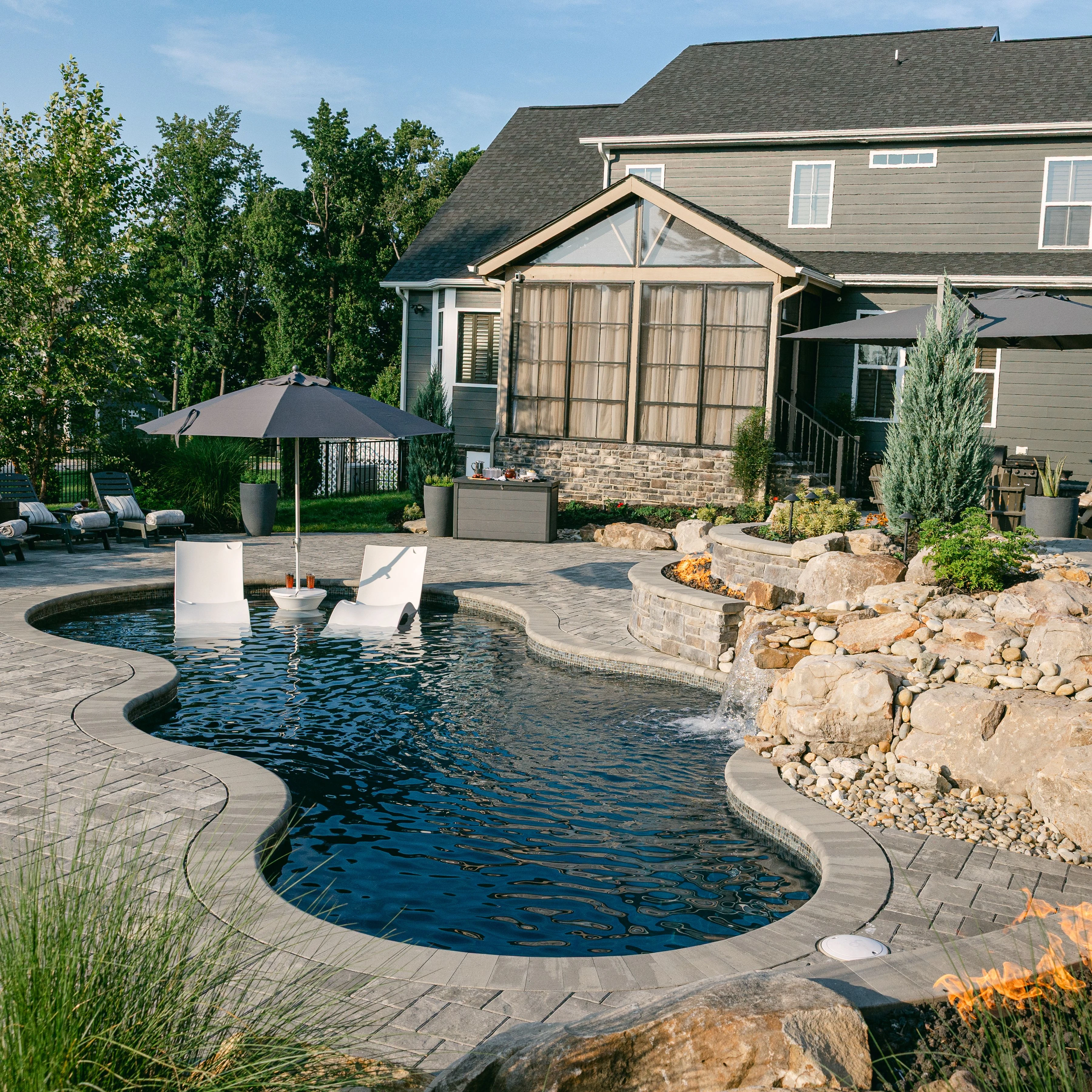 Luxury backyard poolscape featuring Night Sky Crystal finish and sweeping curves