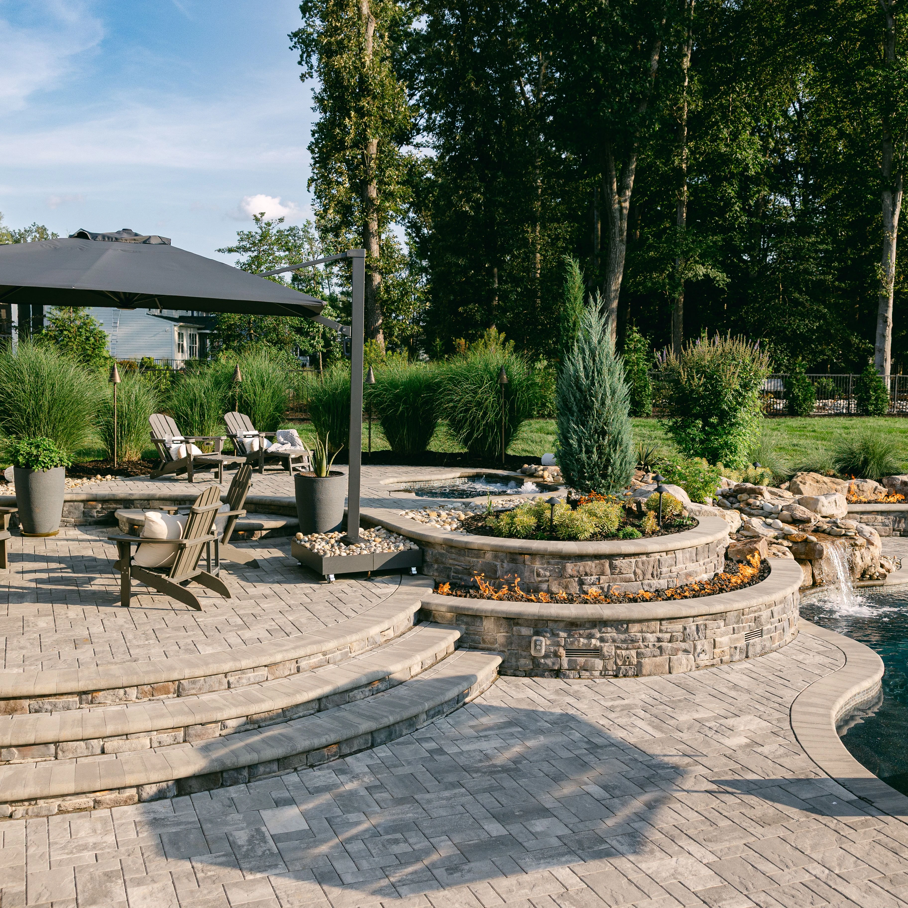 Three-level hardscape with stone caps and ornamental planting
