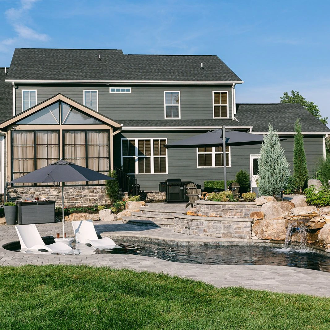 Tiered backyard with integrated fiberglass pool and spa from Latham Pools