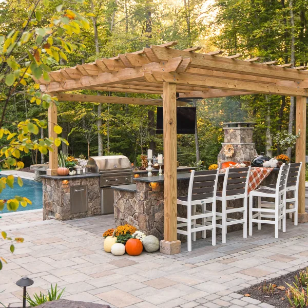 Pergola installed over backyard kitchen near the pool