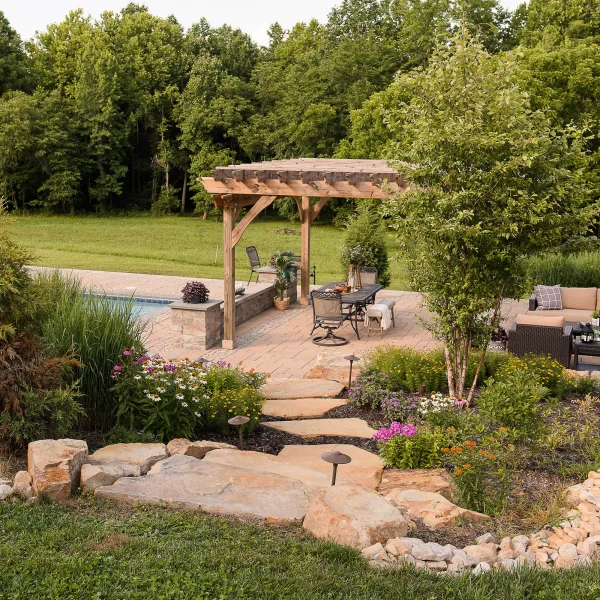 Paver patio with pergola, gunite pool, and native landscaping