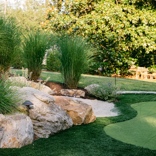 putting green wtih boulders and landscaping