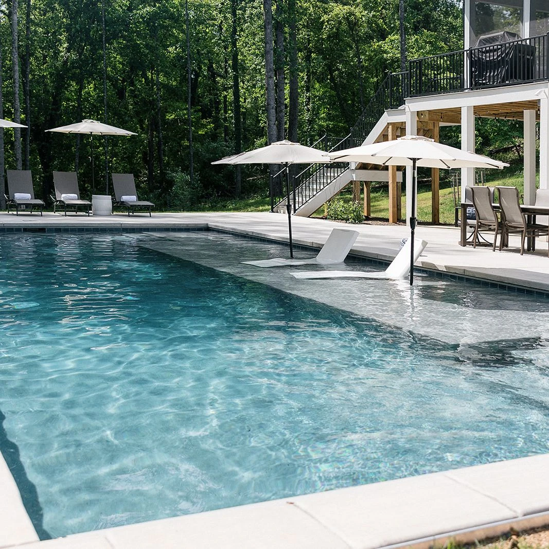 Elegant backyard design with integrated pool and ambient lighting