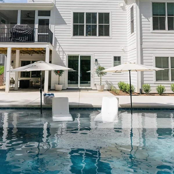 Inground pool with Balboa 6x6 tile and low-maintenance brushed concrete deck