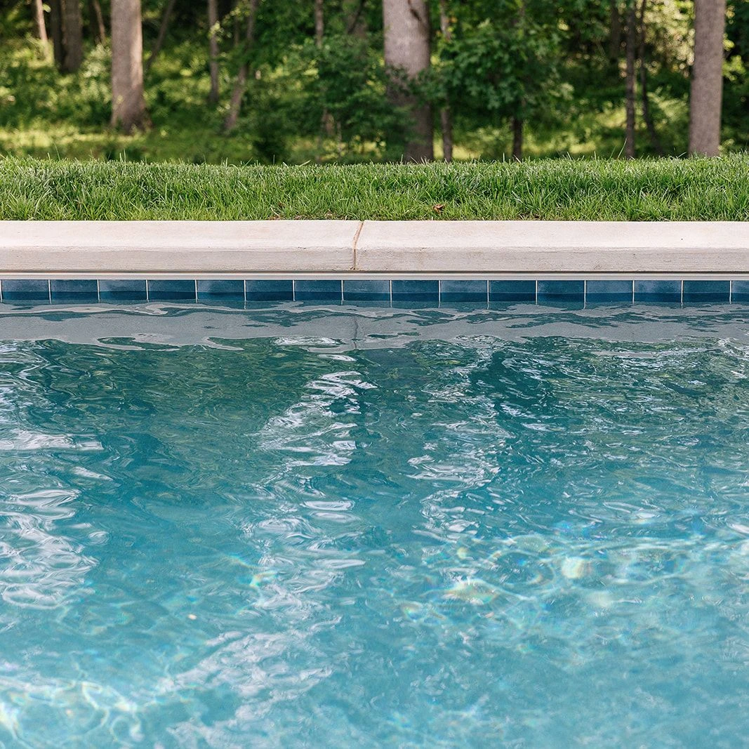Poolside hardscape with brushed concrete and subtle texturing