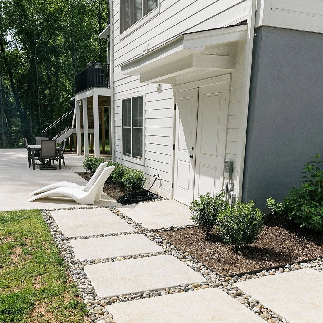 Stepping stone walkway through landscaped garden beside pool