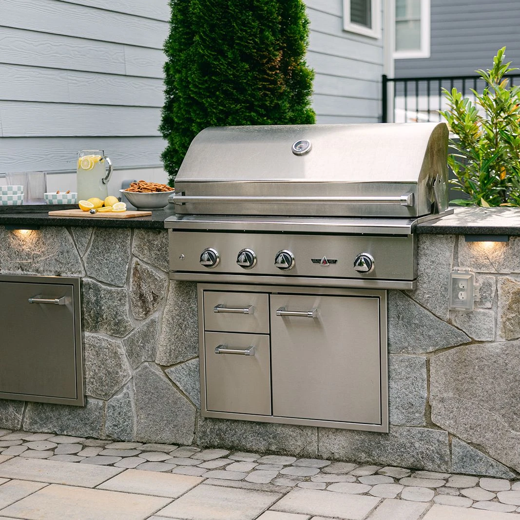 Outdoor kitchen with stone surround and built-in grill