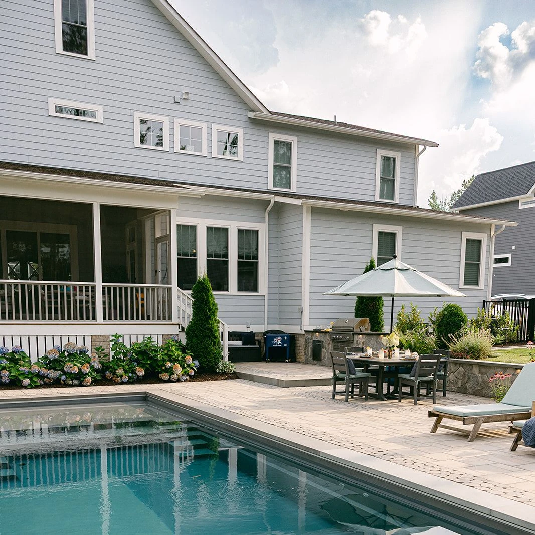 Poolside lounge chairs facing fiberglass pool