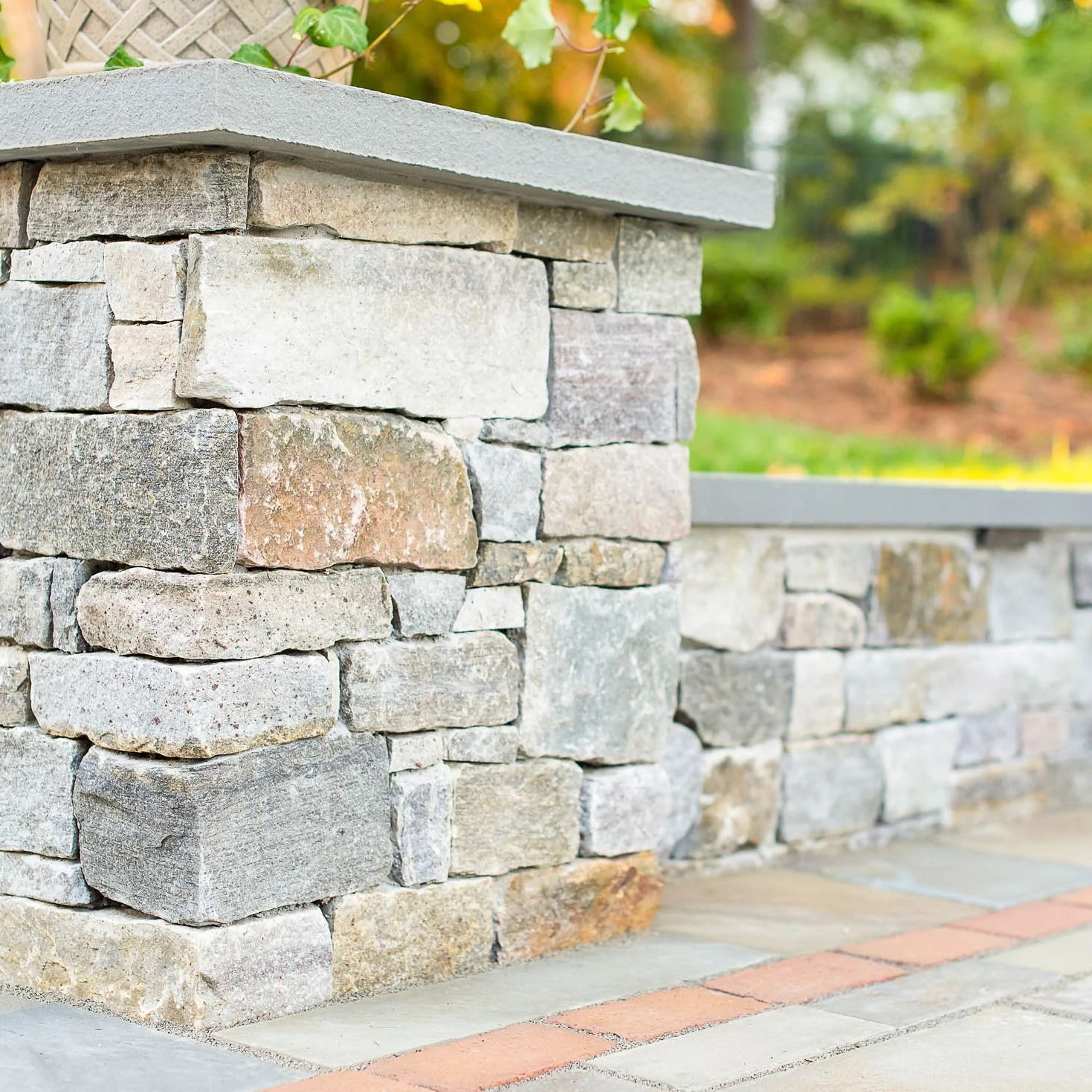 Stacked veneer stone column corner of a sitting wall
