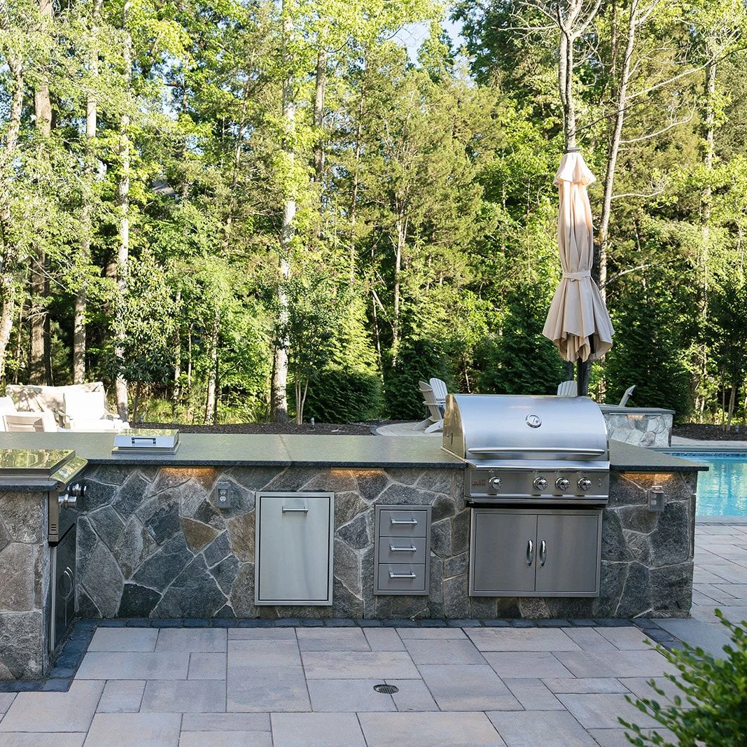 Backyard kitchen with leathered Silver Pearl granite and built-in appliances