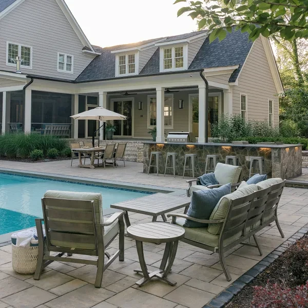 Elegant backyard poolscape with stone patio and integrated fire pit
