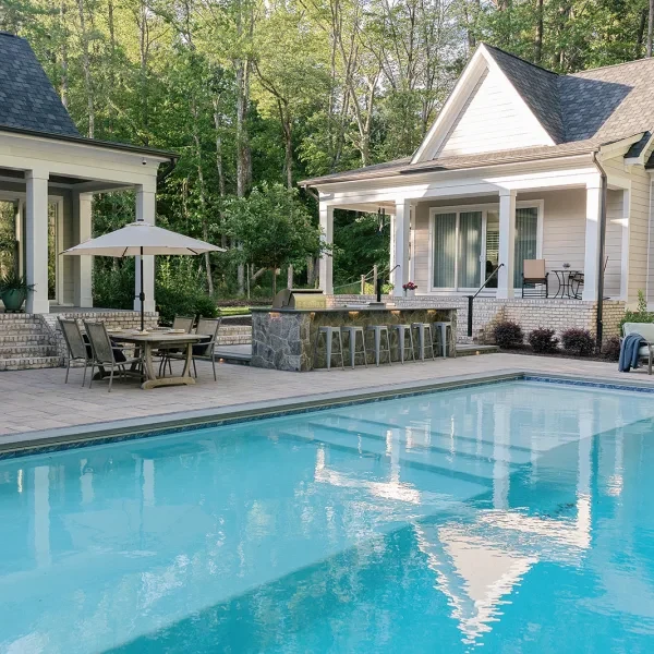 Large custom gunite pool with swim lane and wall fountain feature