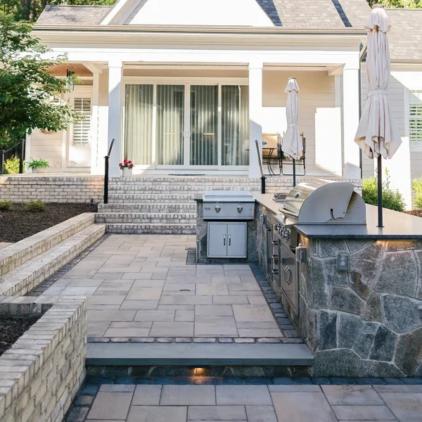 Multi-level patio with Unilock slabs and stone veneer walls