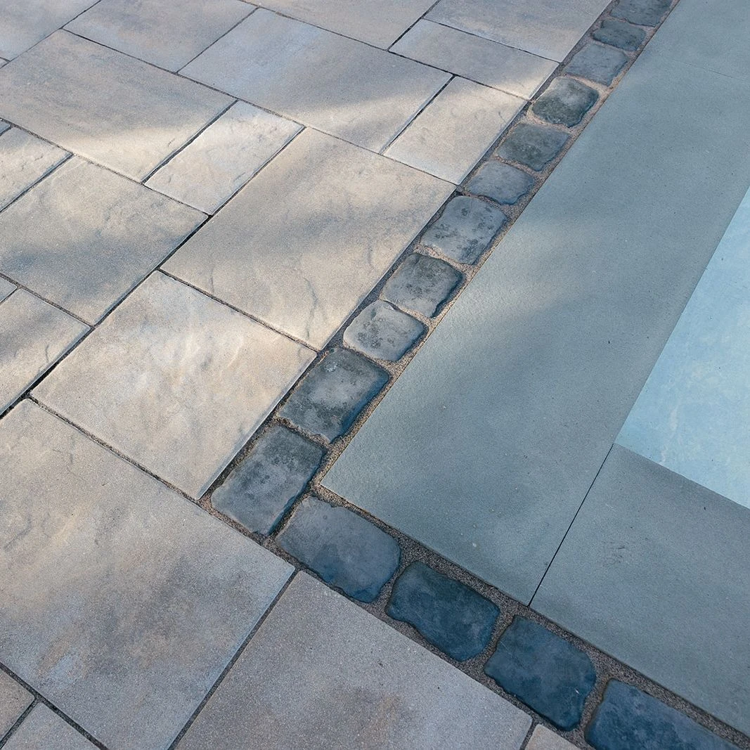 Unilock Beacon Hill slab pool deck with Courtstone paver border
