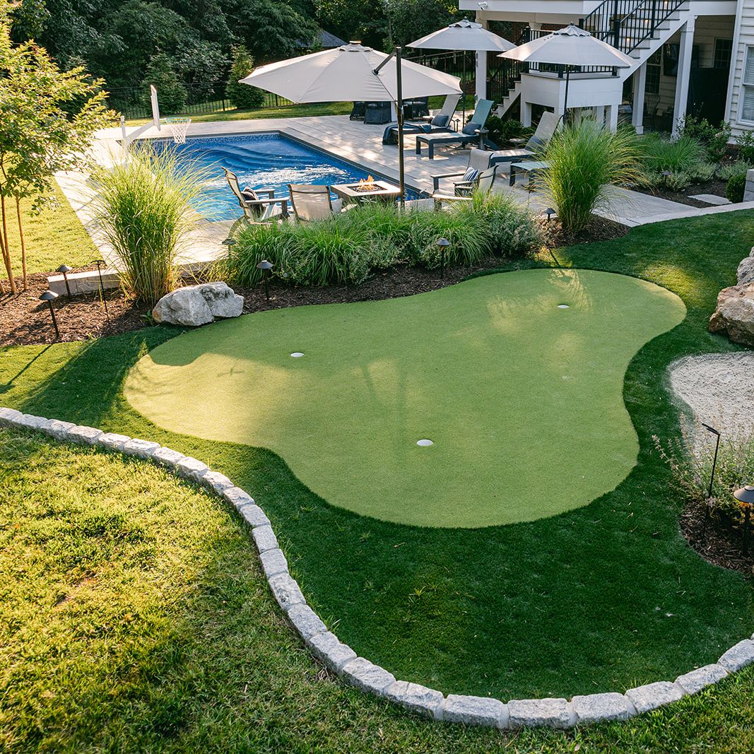 Putting green with pool in the background