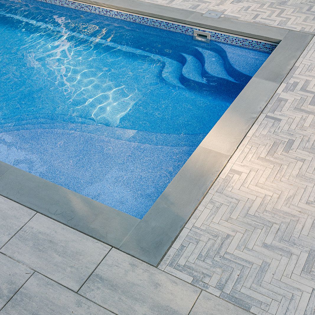 fiberglass swimming pool with unique techo bloc paver pool decking