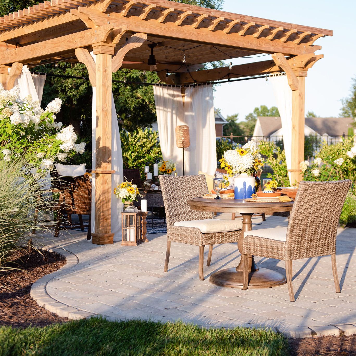 Paver patio with a dining area and pergola covered lounge area
