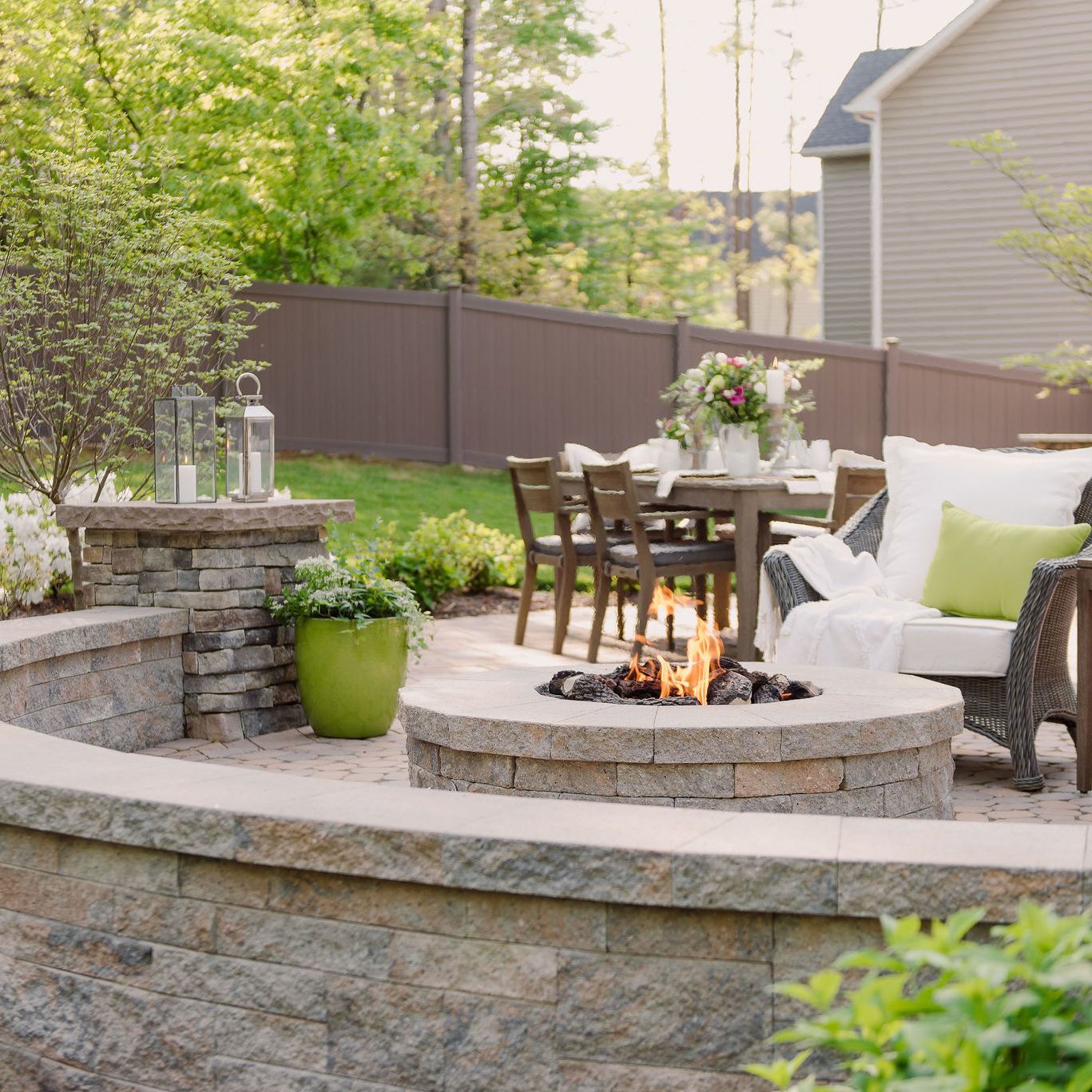 Gas fire pit with sitting wall and pillars.