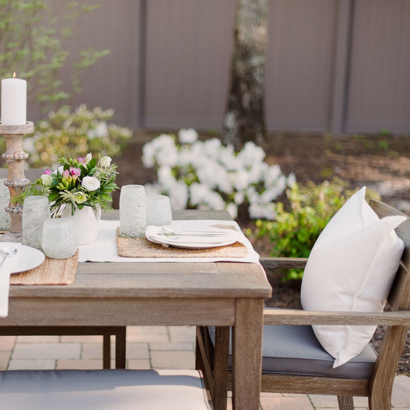 Outdoor Dining Table setting on a paver patio.