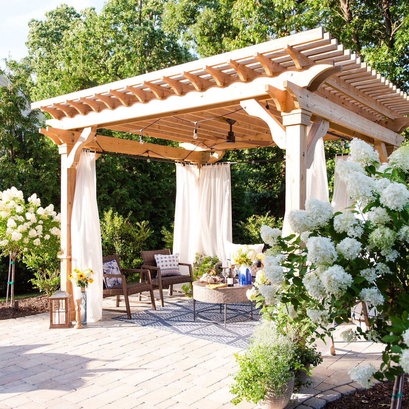 Paver patio with pergola with curtains