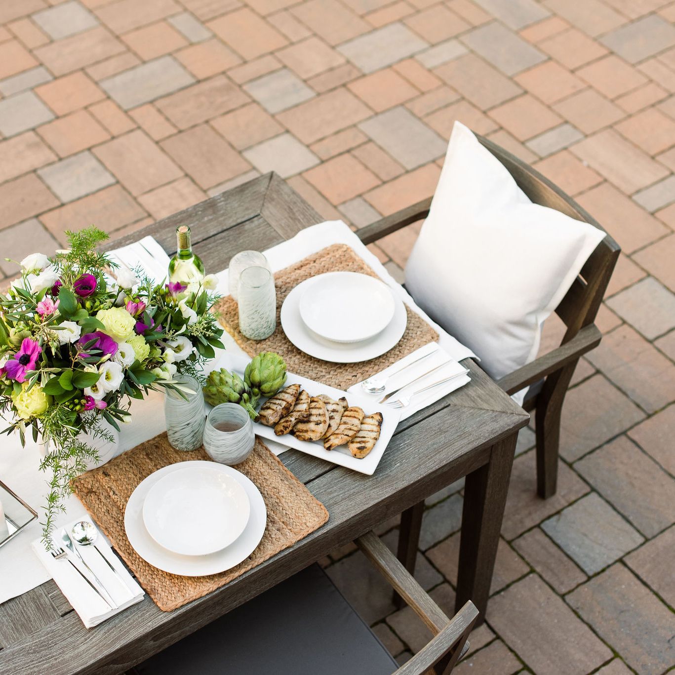 outdoor dining table setting on a Techo-Bloc paver patio.