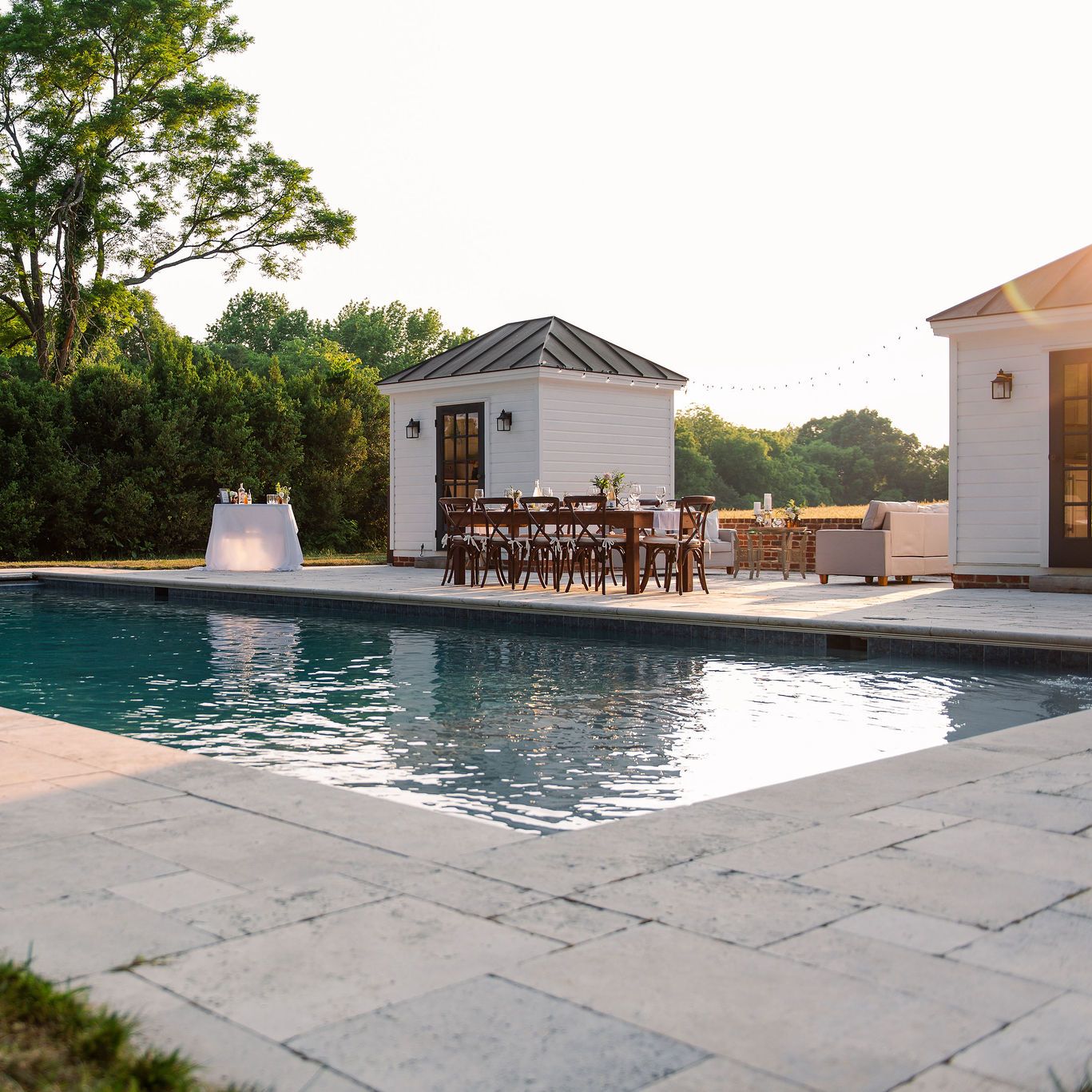 Pool with travertine decking and two cabanas
