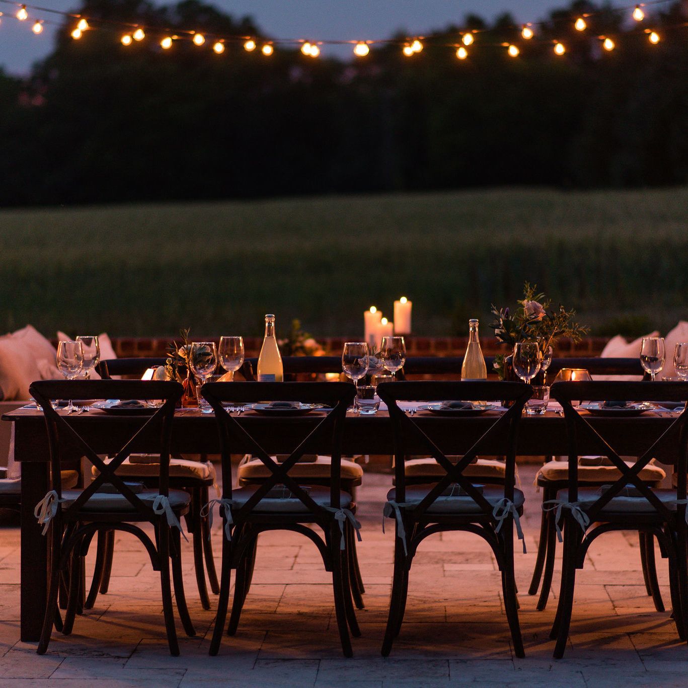 Elegant outdoor dinner party with string lights