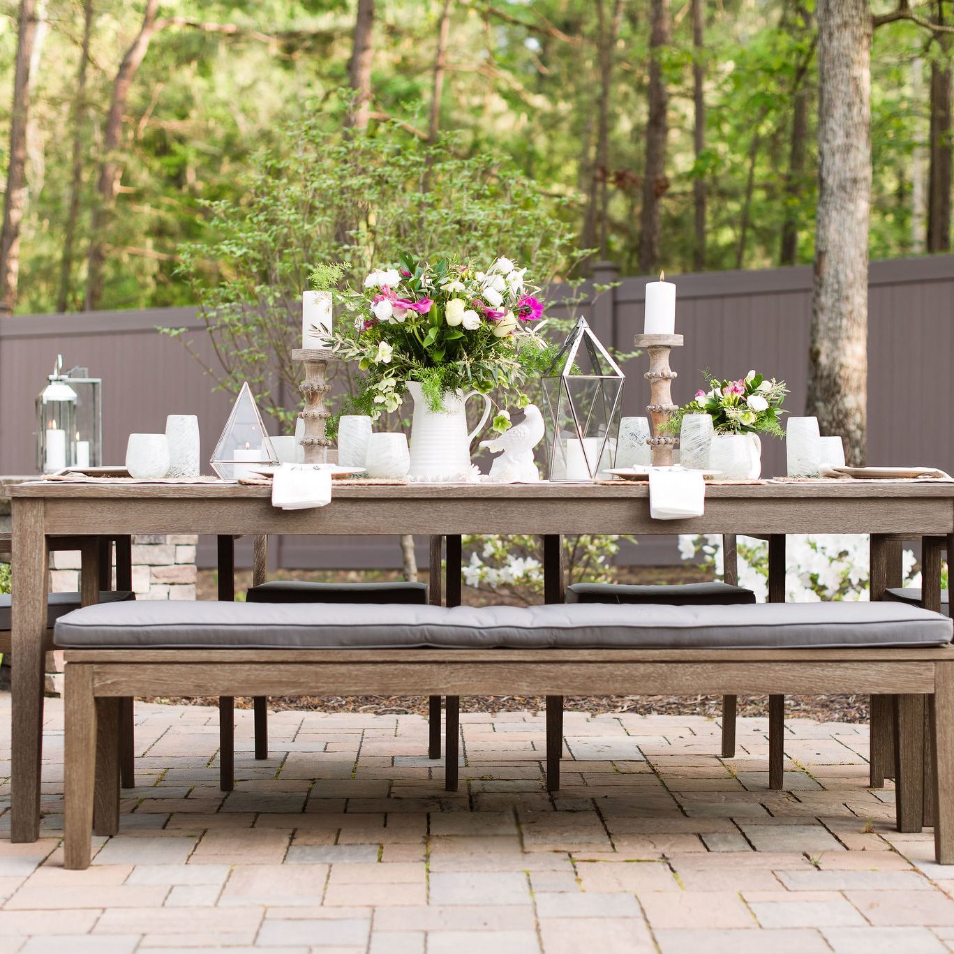 Outdoor dining table on a Techo-bloc paver patio.
