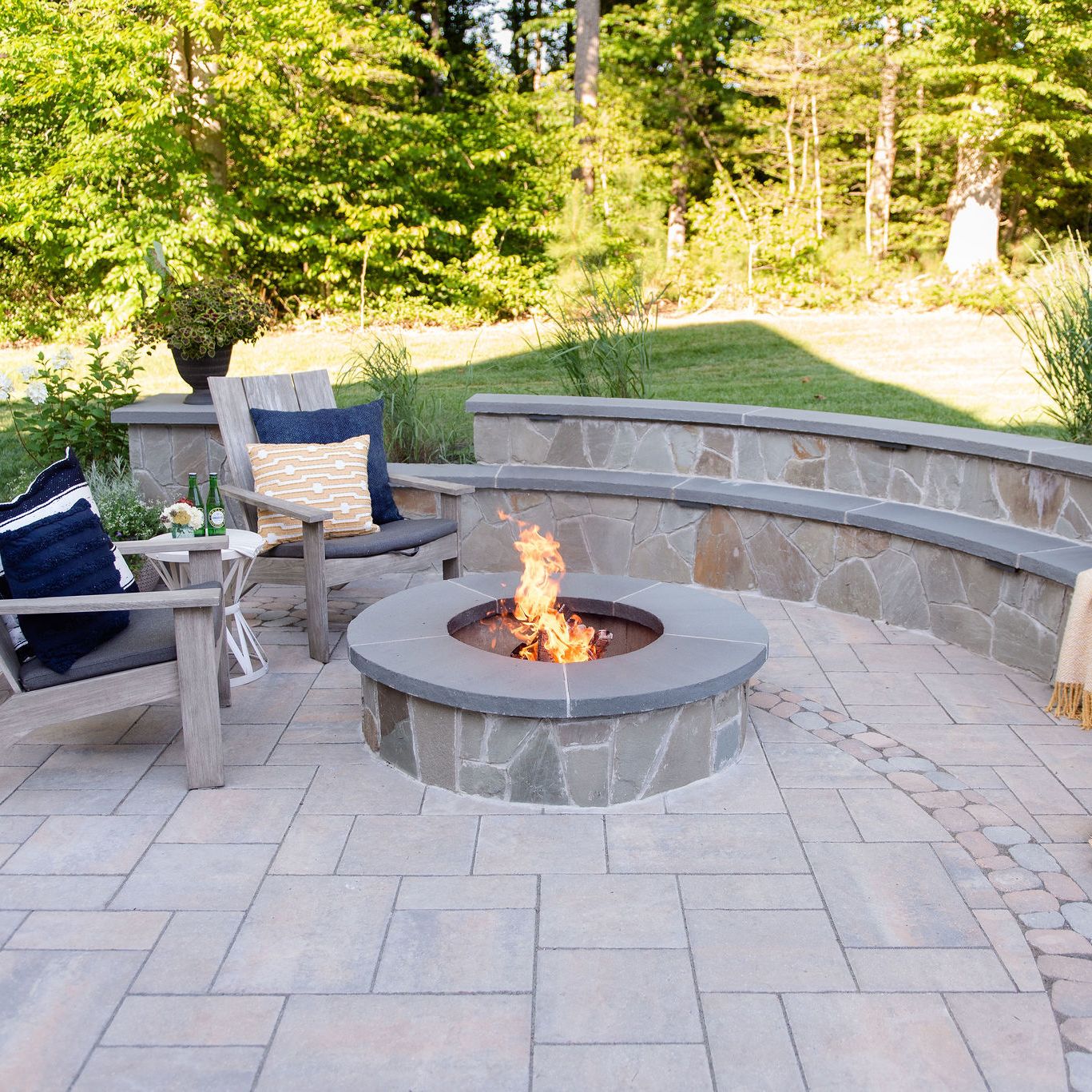 Wood burning fire pit with bench-style sitting walls