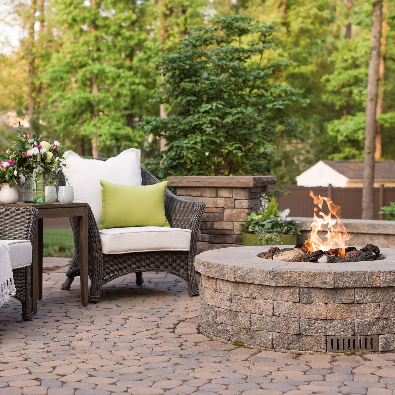 Gas fire pit on a paver patio.