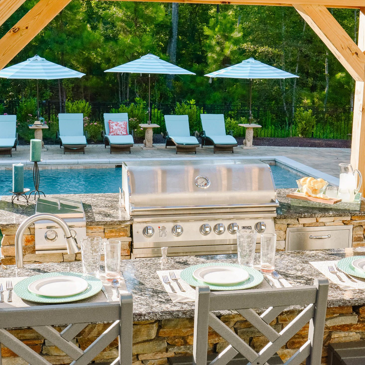 backyard kitchen with granite countertops and steel gas grill