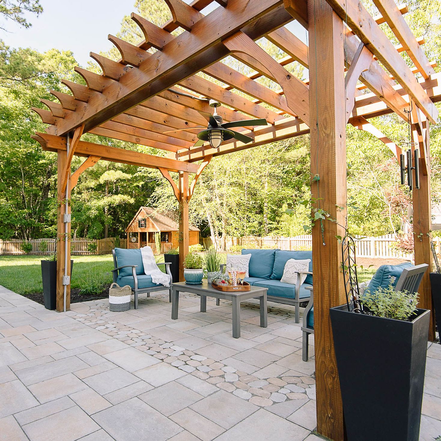 Stained large pergola installed in backyard with fan