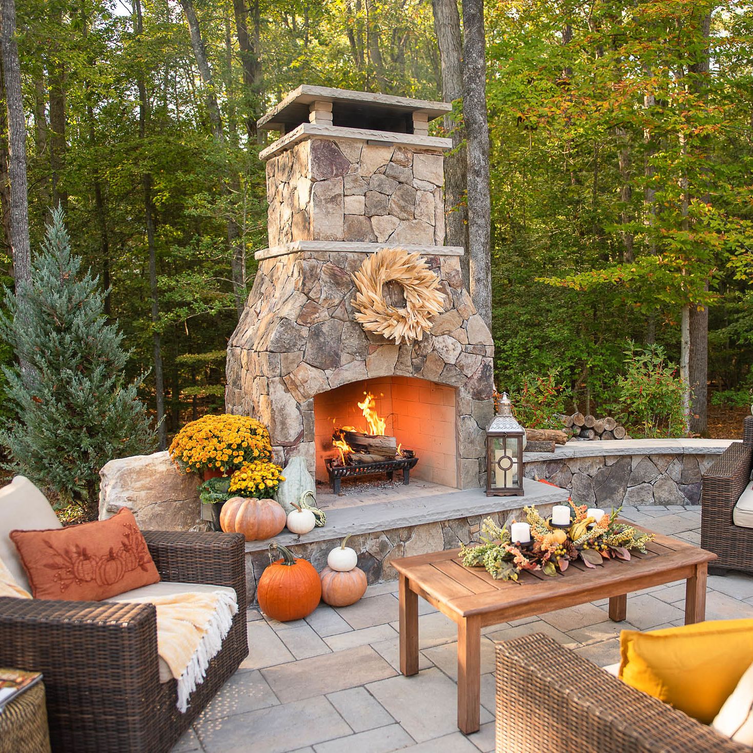 classic high-end fireplace installed into backyard patio with large hearth