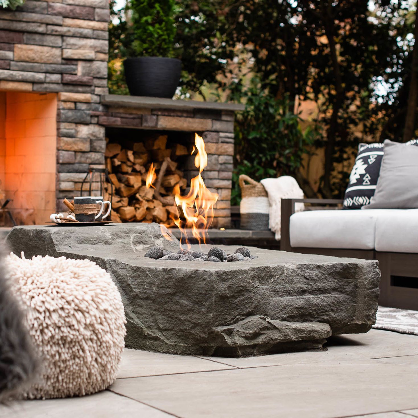 dark grey gas-burning fire boulder burning  nearby the fire place