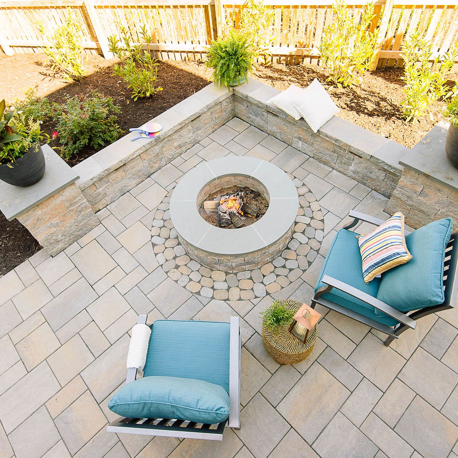 view from the top backyard paver patio and fire pit